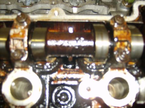 1996 Ford Probe - Close-up view of an engine's camshaft and associated components, covered in oil.