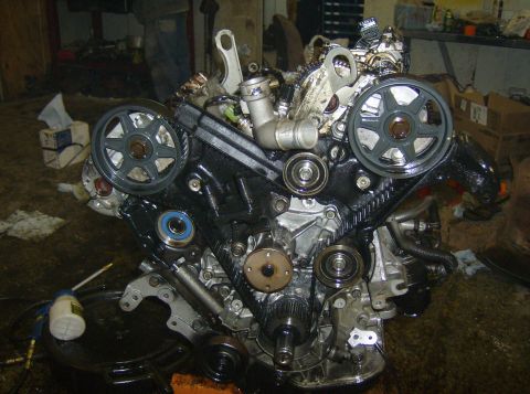 1996 Ford Probe - A complex engine assembly is shown, with various belts and pulleys prominently displayed.