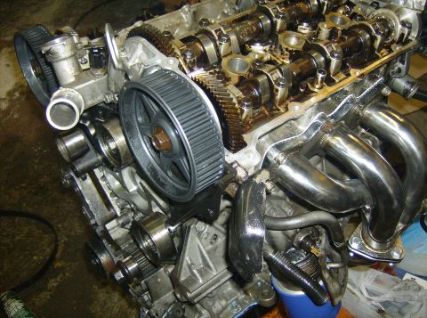 1996 Ford Probe - Close-up view of an engine's internal components, including the timing belt, gears, and camshafts.