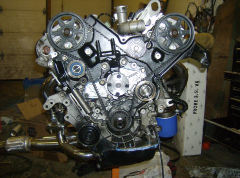 1996 Ford Probe - Engine assembly with timing belts and pulleys. Box in background indicates it is for a Probe 2.5L V6.