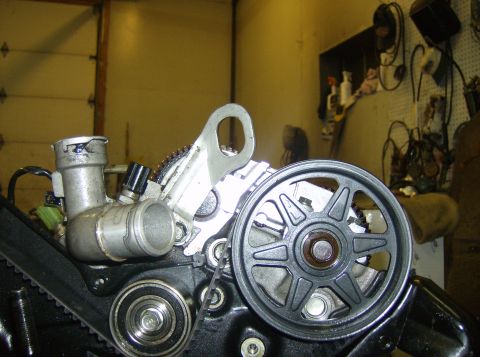 1996 Ford Probe - Close-up view of engine components, including a pulley, belt, and hoses.