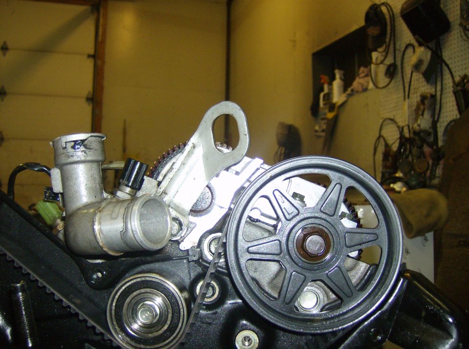 Engine pulley and belt system with metal hoses and sensors