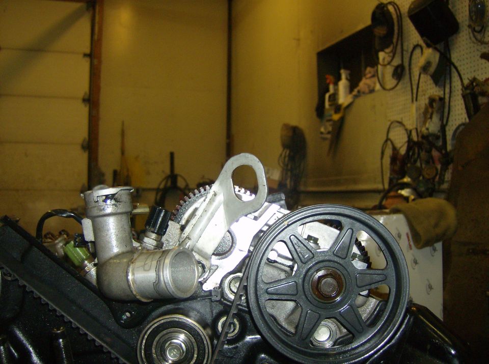 Engine pulley and water outlet assembly
