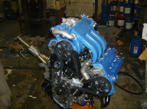 1996 Ford Probe - Engine assembly with blue intake manifold and exhaust components visible.
