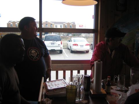 1996 Ford Bronco - View from inside a restaurant shows two parked vehicles in the lot outside.
