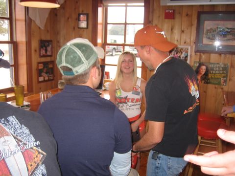 1996 Ford Bronco - A group of people interact at the bar of a Hooters restaurant.