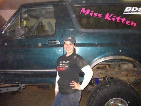 1995 Ford Bronco - Person stands next to a 1995 Ford Bronco, which has a 'Miss Kitten' sticker on the rear window.
