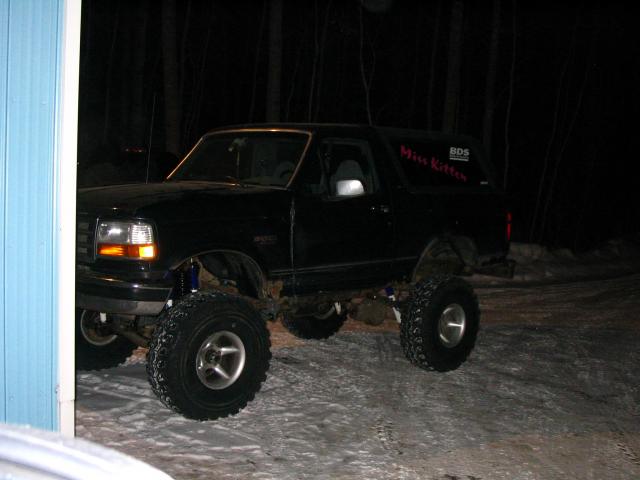 Black lifted Ford Bronco with large tires, "Miss Kitten" sticker on rear quarter panel