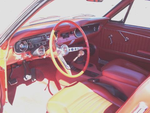 1965 Ford Mustang - Interior view of a 1965 Ford Mustang, showing the dashboard, steering wheel, and seats.