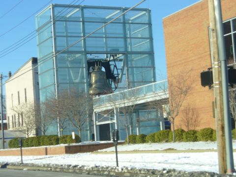 1991 Ford Probe - The Liberty Bell is displayed within a glass enclosure, a landmark in a city setting.