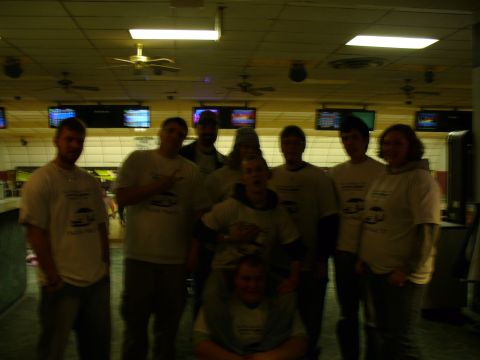 1991 Ford Probe - A group of friends gathered in a bowling alley, with some individuals wearing matching t-shirts.