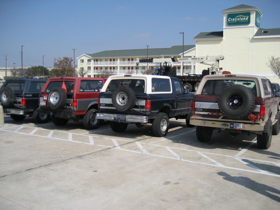Rear view of a tan 1987 Ford Bronco with a spare tire mounted on the back