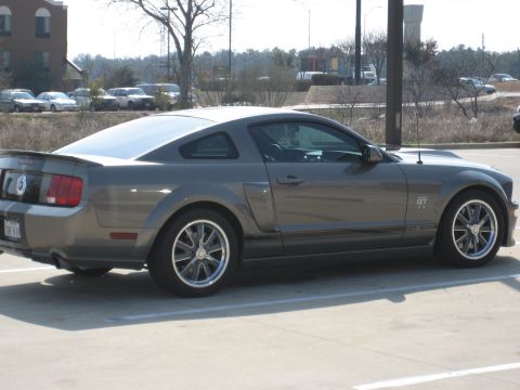 1986 Ford Bronco - This gray Ford Mustang GT 500 is seen from the rear quarter angle in a parking lot.
