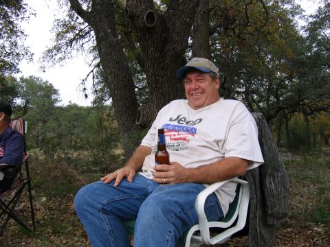 1996 Ford Bronco - Man enjoys a beer while sitting outdoors under a tree.