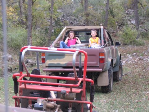 1996 Ford Bronco - Children ride in the back of a pickup truck during an outdoor excursion.