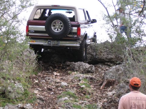 1996 Ford Bronco - This 1996 Ford Bronco navigates a challenging rocky incline, its off-road capabilities.