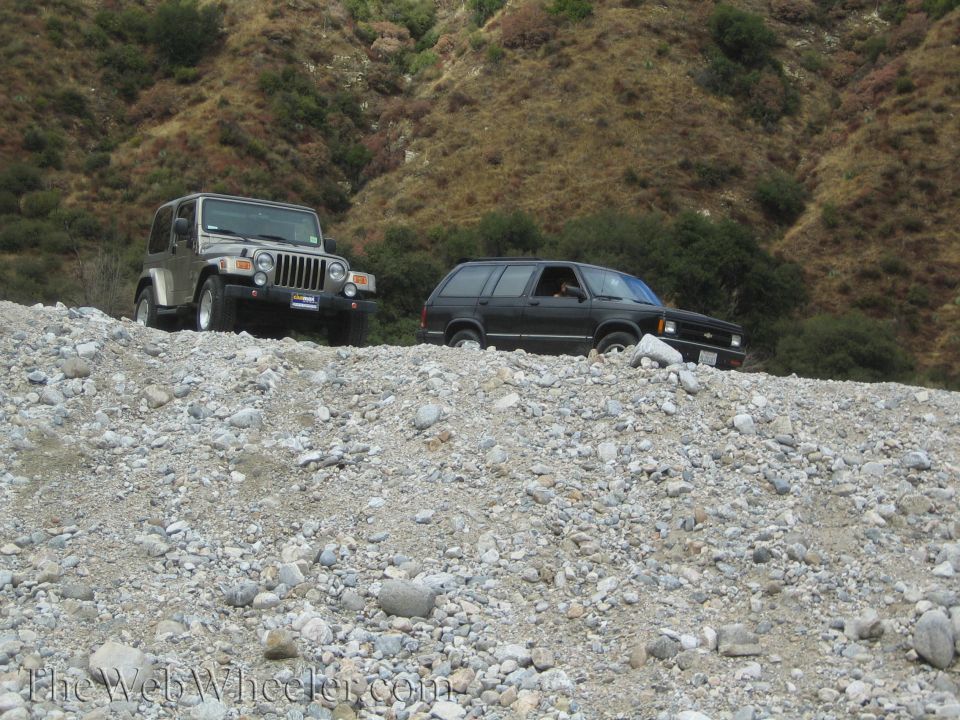Jeep Wrangler and Chevrolet S-10 Blazer on a rocky incline
