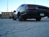 1992 Ford Crown Victoria - Rear view of a 1992 Ford Crown Victoria, showing its distinctive taillight and body lines.