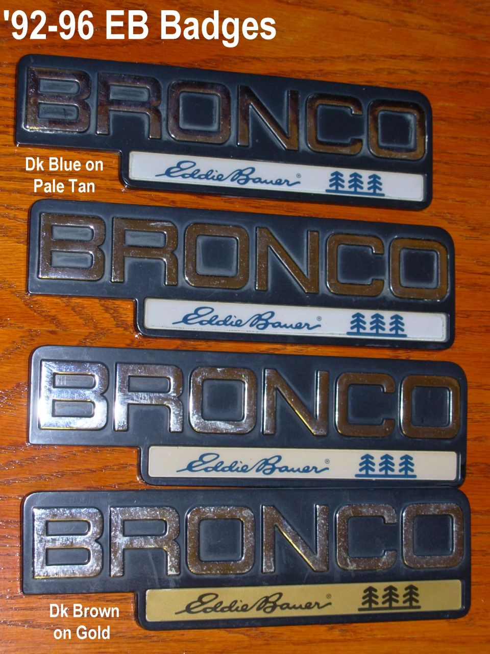 Four Ford Bronco Eddie Bauer emblem badges in different colors