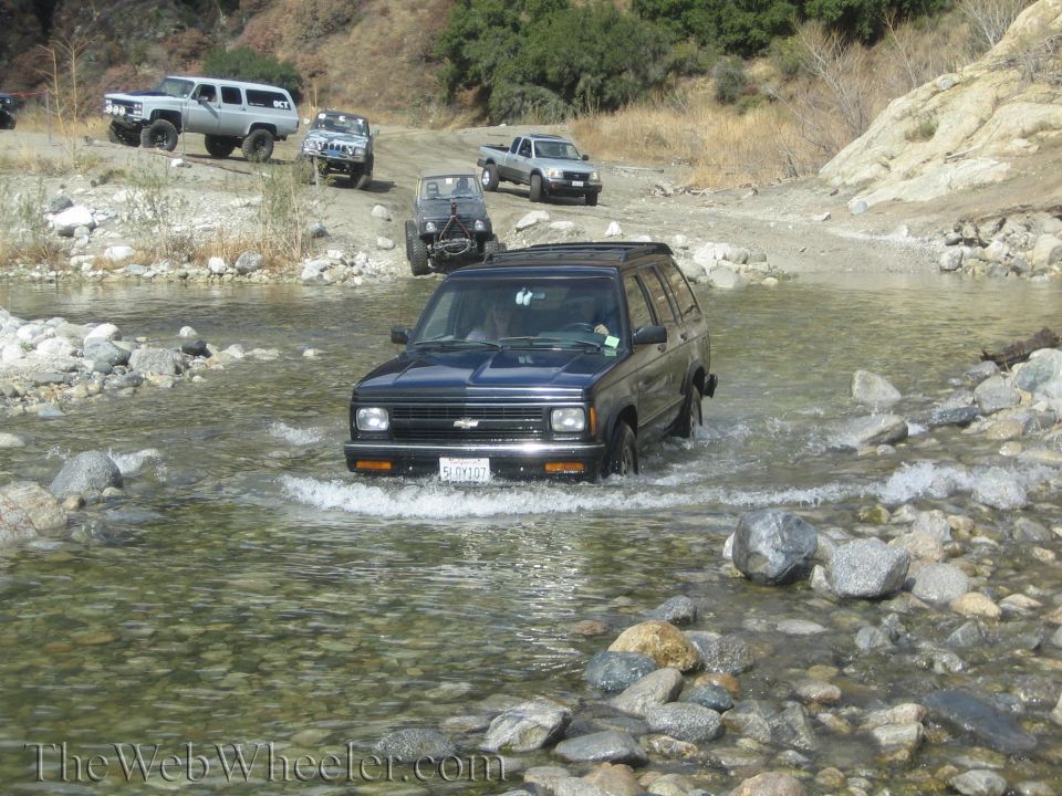 Dark blue 1991 Chevrolet S-10 Blazer crossing a stream, front view