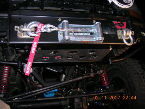 1996 Ford Bronco - Undercarriage view of a vehicle's front bumper with a winch and suspension components.