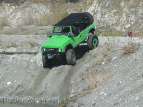 1987 Suzuki Samurai - A modified 1987 Suzuki Samurai navigates a challenging off-road terrain.