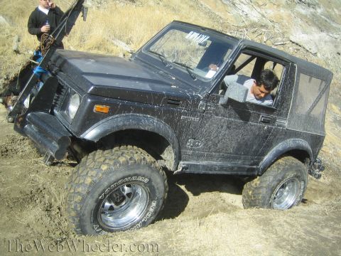 1987 Suzuki Samurai - This 1987 Suzuki Samurai is stuck in the dirt, with a winch attached to the front.