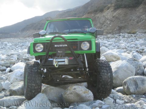 1987 Suzuki Samurai - This 1987 Suzuki Samurai is shown in a front view, equipped with a winch and navigating a rocky, off-road environment.