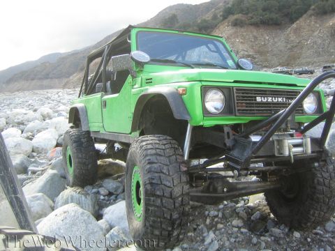 1987 Suzuki Samurai - Modified 1987 Suzuki Samurai navigating a rocky terrain.