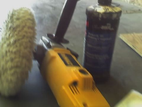 1993 Ford C-350 (Centurion Conversions) - Polishing equipment including a buffer and compound bottle are laid out on a surface.
