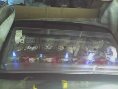 1993 Ford C-350 (Centurion Conversions) - The interior of a vehicle canopy shows a custom lighting setup with visible wiring and blue LEDs.