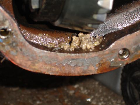 1989 Ford Bronco - Close-up of differential housing with accumulated sludge and rust.