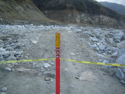 1987 Suzuki Samurai - A sign indicates the area is closed, with caution tape stretched across a rocky, muddy path.
