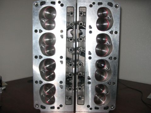 1991 Ford Bronco - Close-up view of two aluminum engine cylinder heads, showing their internal porting.