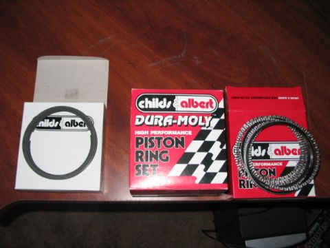1991 Ford Bronco - Several sets of Childs & Albert piston rings are displayed on a table.
