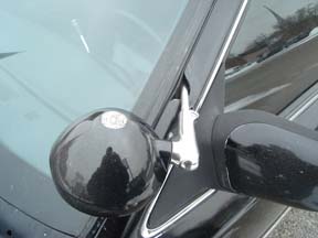 1992 Ford Crown Victoria - Detail of a police spotlight attached to the side mirror of a car.