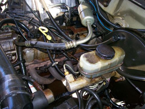 1992 Ford Bronco - Close-up view of a vehicle's engine bay, showing various components and wiring.