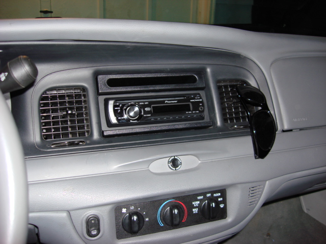 2003 Ford Crown Victoria interior showing dashboard, Pioneer radio, and air vents with sunglasses hanging
