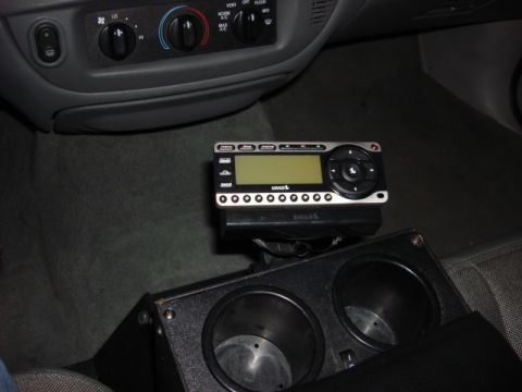 2003 Ford Crown Victoria - A SiriusXM radio is installed above the center console's dual cup holders.