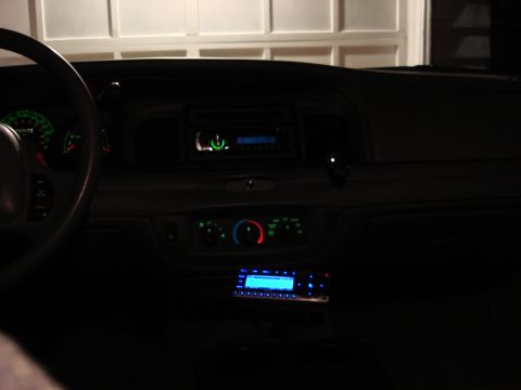2003 Ford Crown Victoria - Dashboard view of a 2003 Ford Crown Victoria, two radios and illuminated gauges.