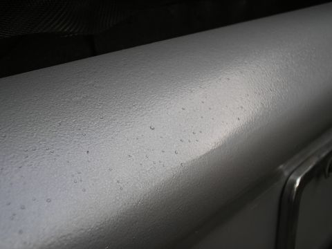 1999 Ford F-800 - close up finish of bumper showing the texture of the hammered silver paint