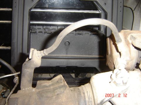 1993 Ford Bronco - Close-up of an engine component with a hose and visible text indicating 'PULL'.