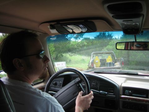 1996 Ford Bronco - A driver looks ahead while driving a pickup truck, with another pickup truck visible in the distance.