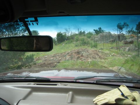 1996 Ford Bronco - Interior view of a 1996 Ford Bronco driving on a rocky, off-road terrain.
