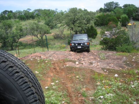 1996 Ford Bronco - A black Land Rover Discovery II navigates a rocky path, with another vehicle visible in the background.