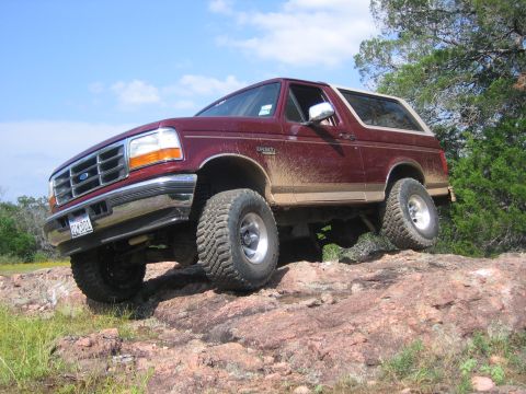 1996 Ford Bronco - 1996 Ford Bronco navigating rocky terrain off-road.