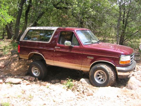 1996 Ford Bronco - This 1996 Ford Bronco navigates a rocky, wooded trail, its off-road capabilities.