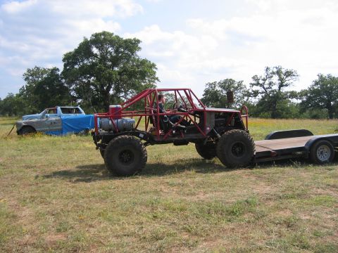 1996 Ford Bronco - Custom buggy and trailer parked in a grassy field next to an old pickup truck.