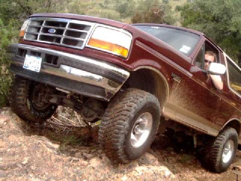 1996 Ford Bronco - This 1996 Ford Bronco is navigating a challenging off-road trail with steep inclines.