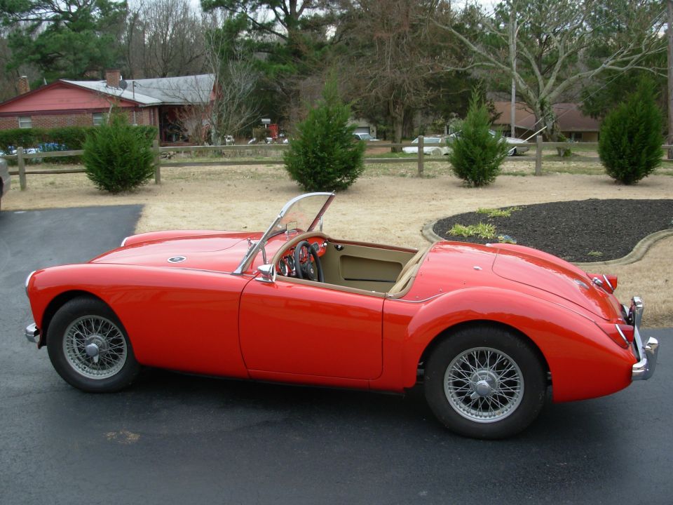Red 1959 MG A convertible sports car, side view